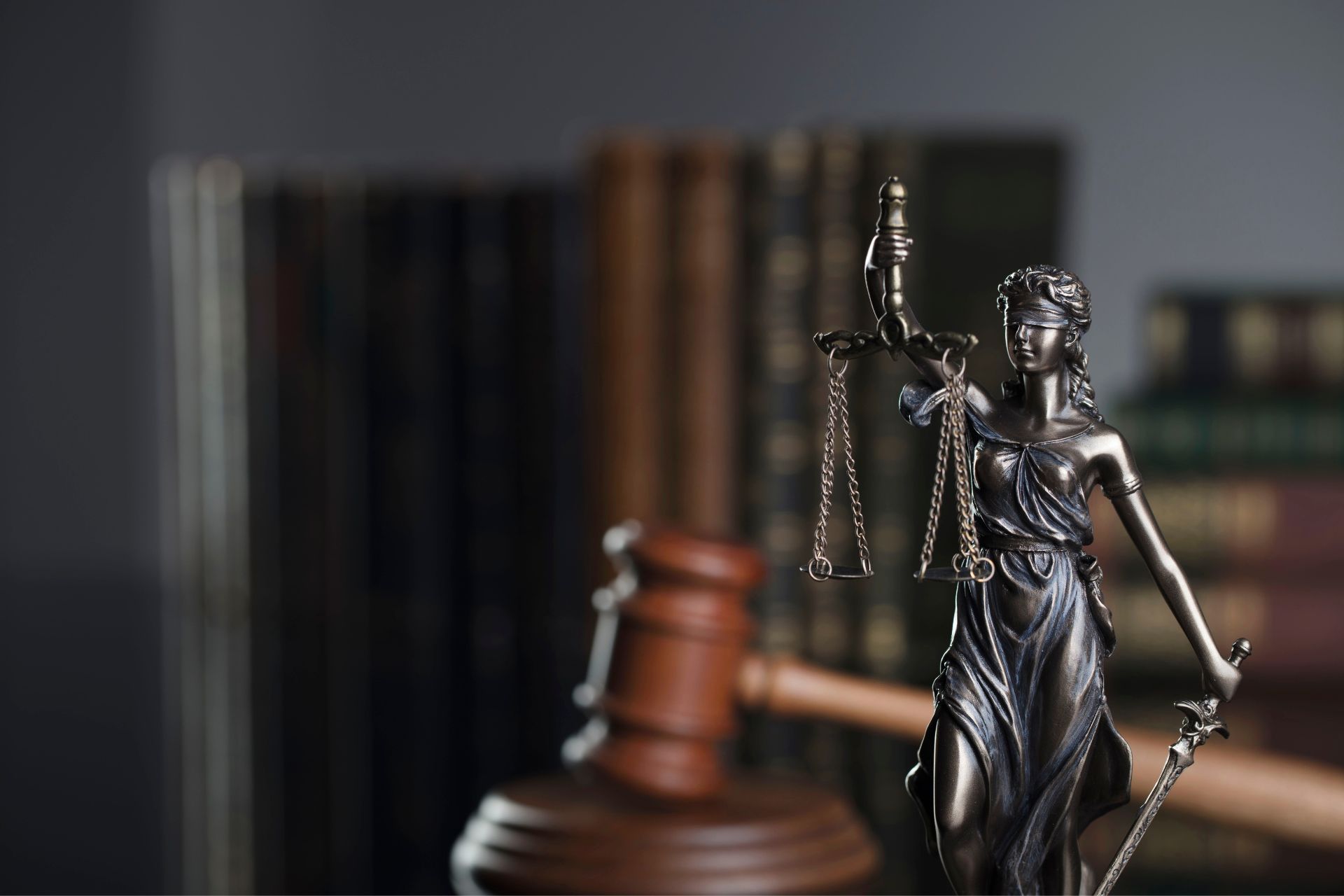 Lady Justice statue and gavel representing corporate and contract law services